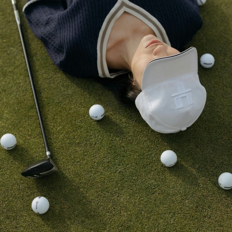 Smiling female golfer walking with her golf bag under the sun