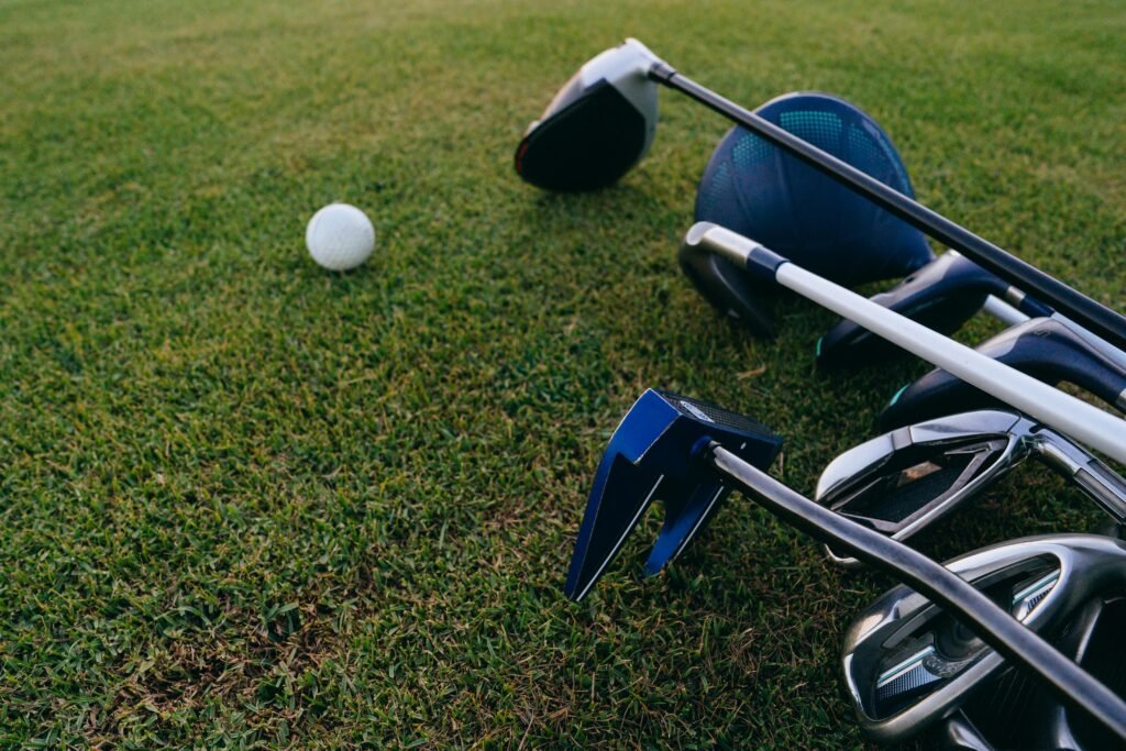 Golfer cleaning clubs with brush on caddy